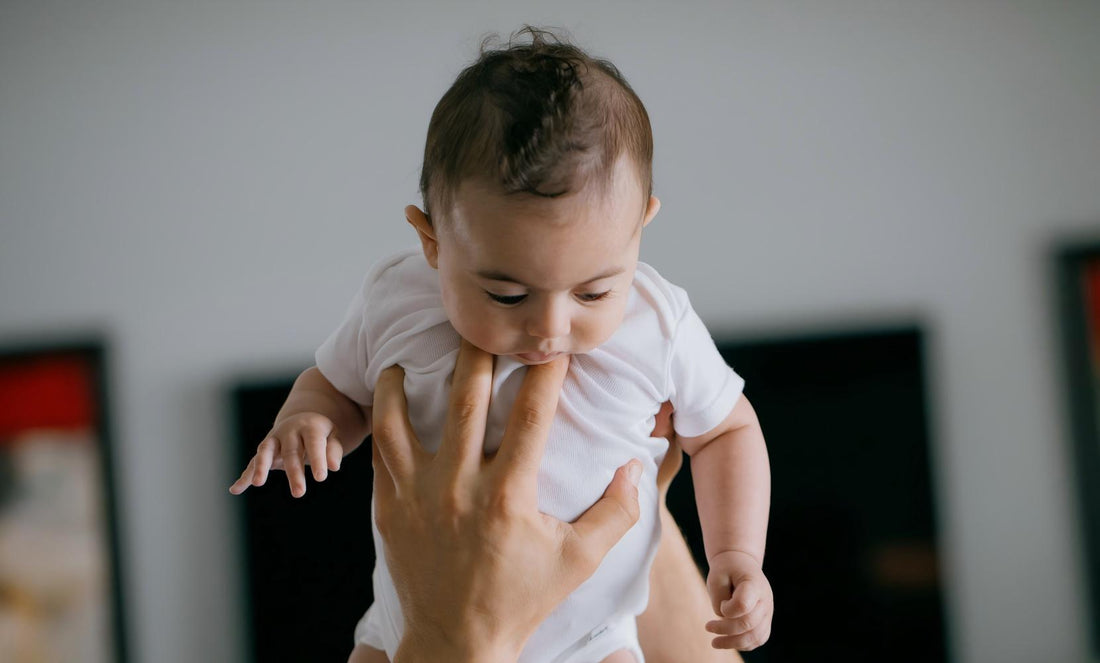 Close up shot of gentle adult hands holding infant baby, soft calm soothing moment, ideal scene for baby rest & parent relaxation sleep aid.